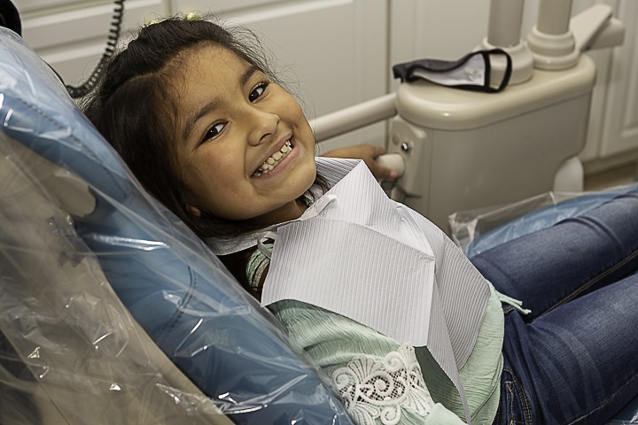 A girl sitting on a dentist chair